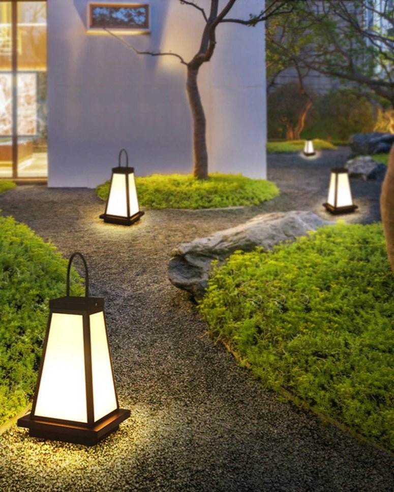 To Lantern casting warm ambient light in a serene garden setting