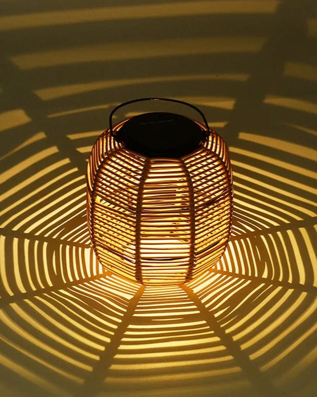 Kago Maru Lantern casting intricate shadow patterns on a surface with warm glowing light.