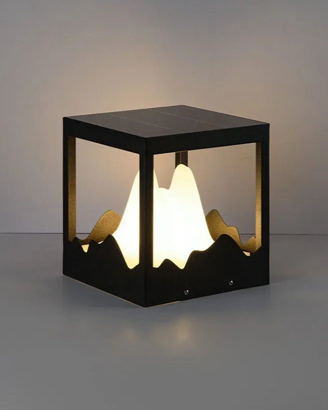 Yama Ground Light showcasing a cubic solar-powered lamp with sculpted glass design inspired by mountain peaks.